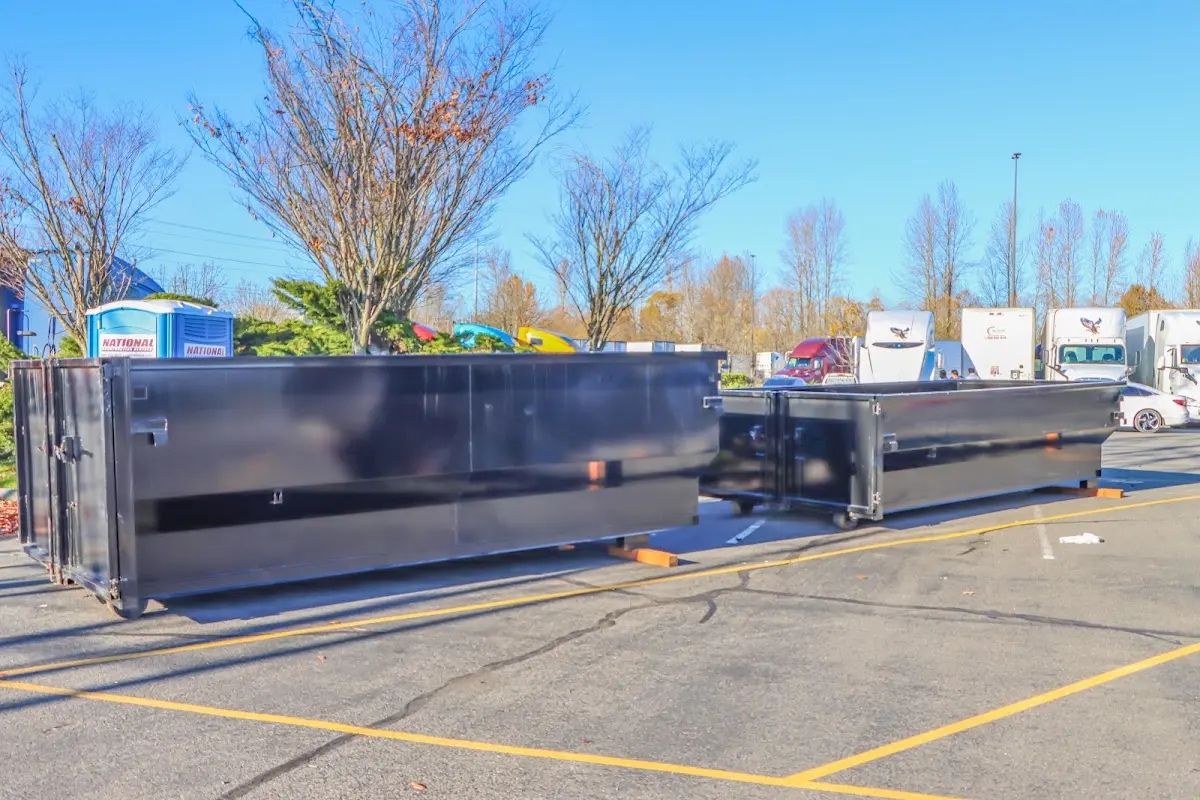 Professional dumpster rental service with roll-off container on residential driveway in East Rutherford